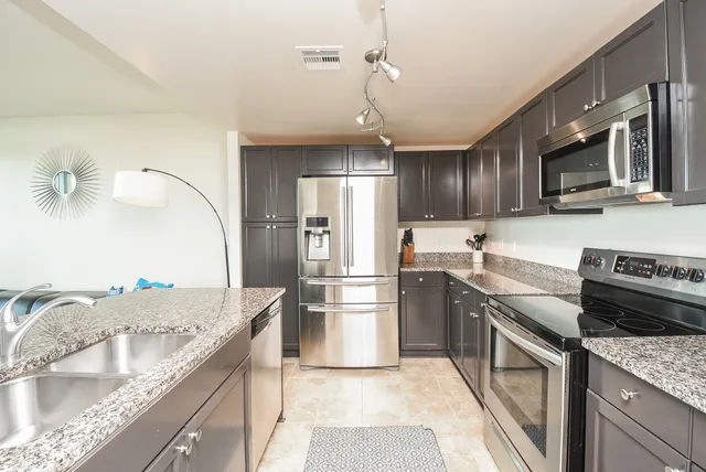 a kitchen with a sink stove and refrigerator