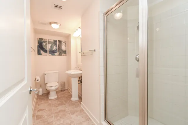 a bathroom with a granite countertop sink a mirror a bathtub and shower