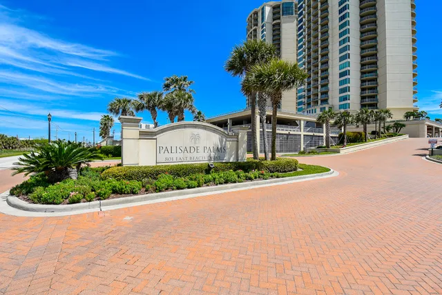 a front view of a house with a yard and outdoor seating