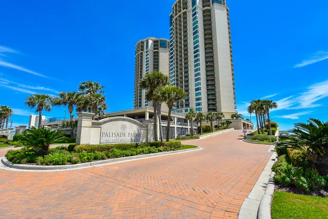 a front view of a building with a yard
