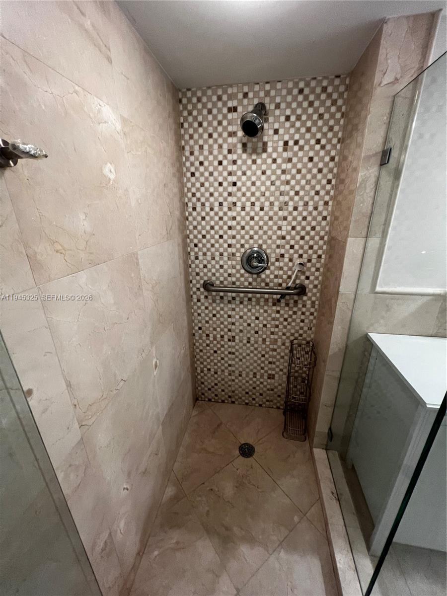 19707 Turnberry Way, Unit 4L Aventura, FL 33180 - Photo 21 of 40 a bathroom with a shower