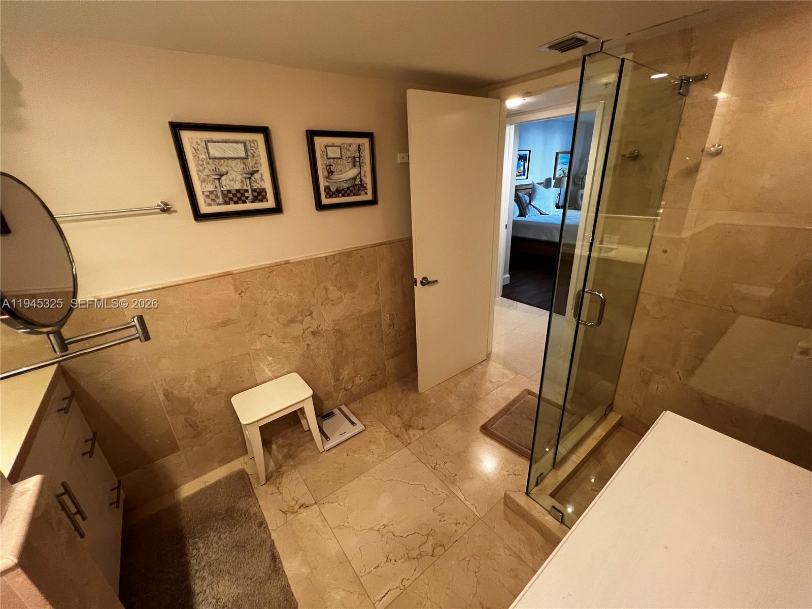 19707 Turnberry Way, Unit 4L Aventura, FL 33180 - Photo 24 of 40 a bathroom with a sink and a mirror