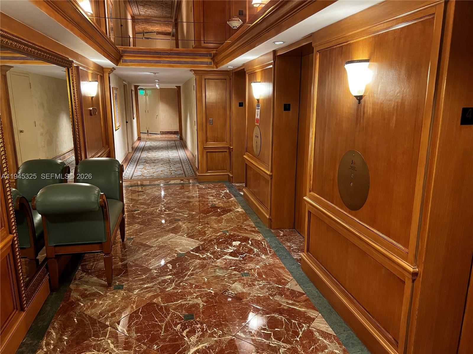 19707 Turnberry Way, Unit 4L Aventura, FL 33180 - Photo 35 of 40 a hallway with furniture and a rug