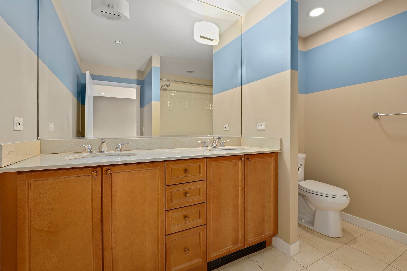737 West Washington Boulevard, Unit 710 Chicago, IL 60661 - Photo 15 of 28 a bathroom with a granite countertop sink toilet and mirror