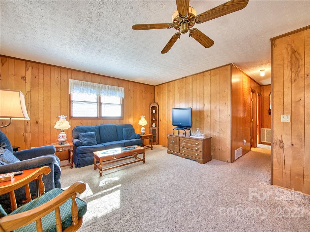 352 Stoney Ridge Loop Maggie Valley, NC 28751 - Photo 12 of 26 a living room with furniture and a flat screen tv