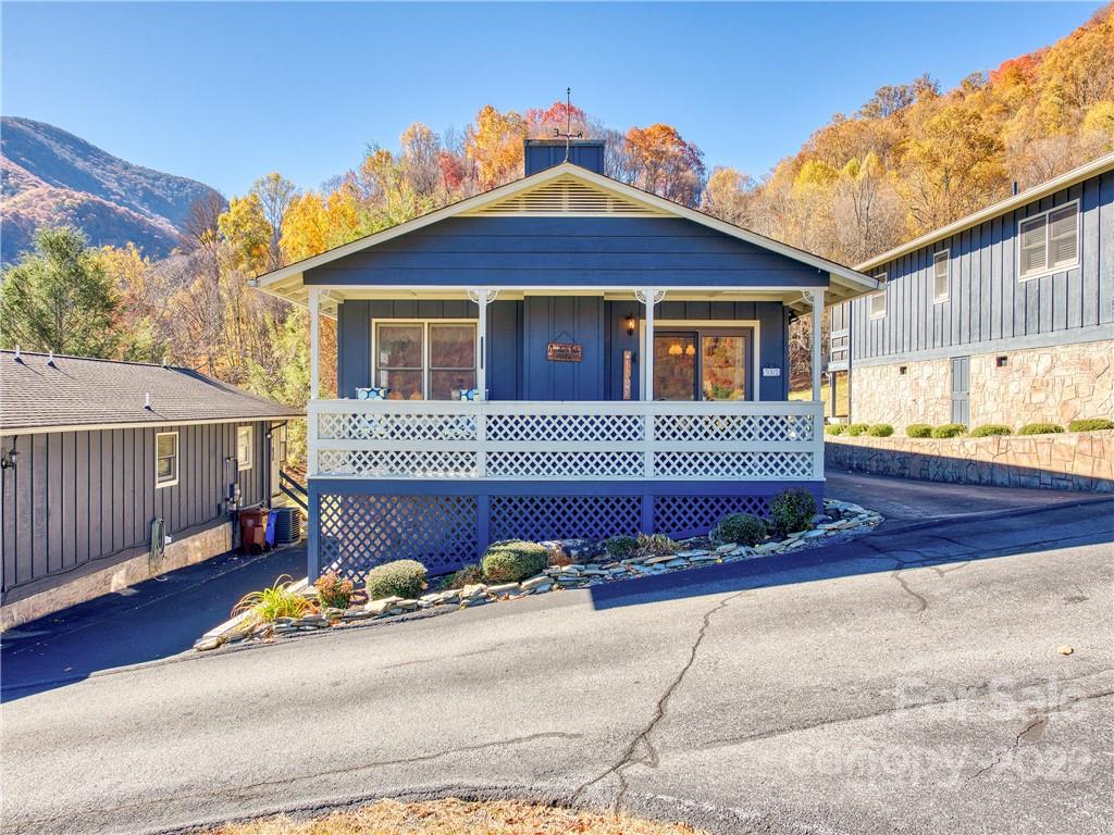 352 Stoney Ridge Loop Maggie Valley, NC 28751 - Photo 2 of 26 a front view of a house with a garage