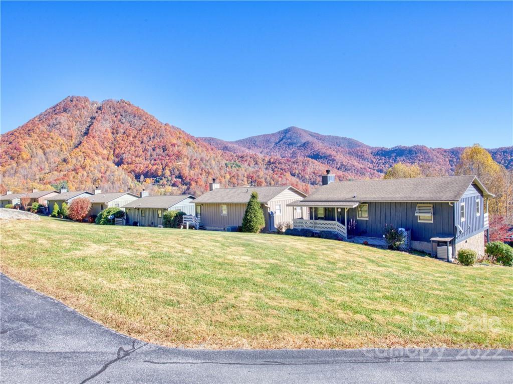 352 Stoney Ridge Loop Maggie Valley, NC 28751 - Photo 4 of 26 a view of a house with a yard