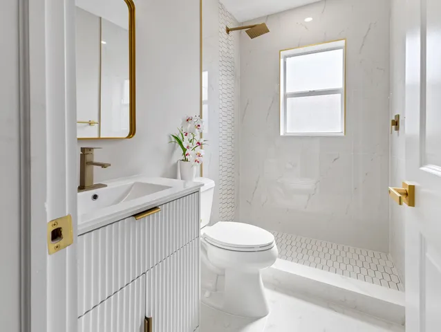 a bathroom with a sink toilet and shower