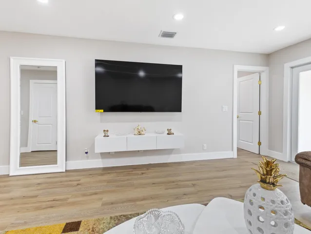 a living room with a flat screen tv and a couch