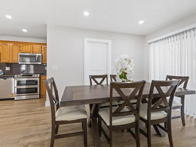 a view of a dining room with furniture and wooden floor