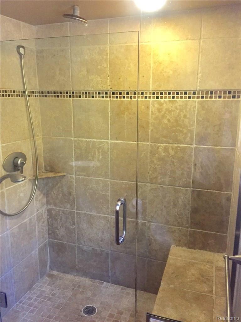 30618 High Valley Road Farmington, MI 48331 - Photo 29 of 46 owner shower with rainhead & handheld, built in seat and frameless glass eurodoor