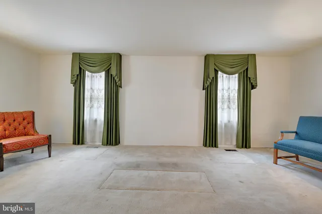 a view of a dining room with furniture and a chandelier