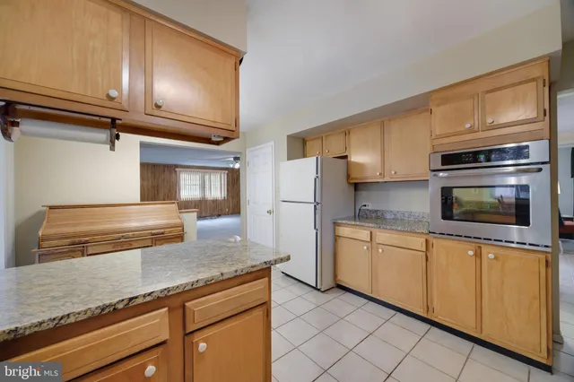 a kitchen with stainless steel appliances granite countertop a sink dishwasher stove and refrigerator
