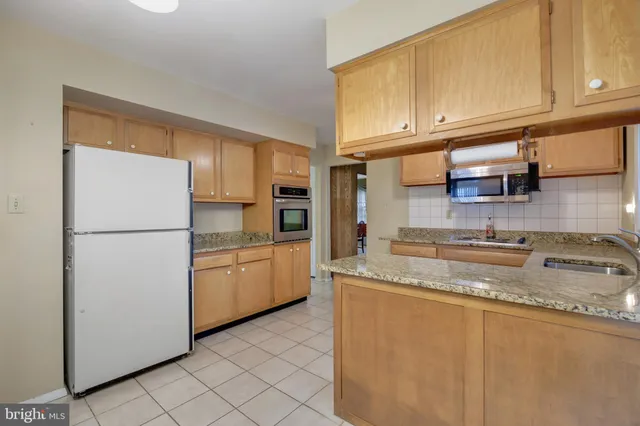 a kitchen with cabinets a sink and a stove