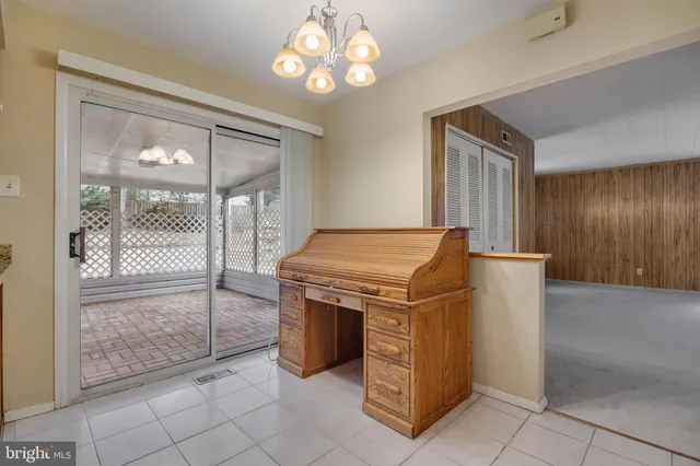 a view of a livingroom with an empty space and a ceiling fan