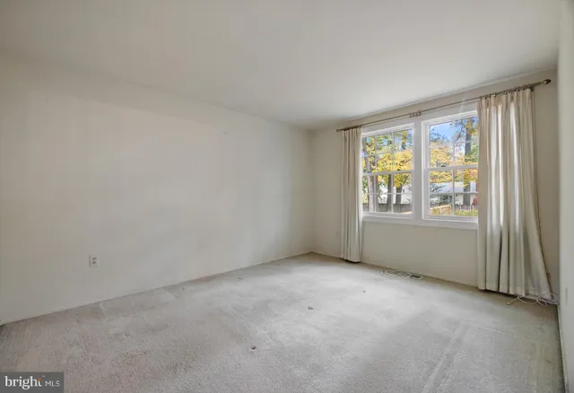 an empty room with windows and walls