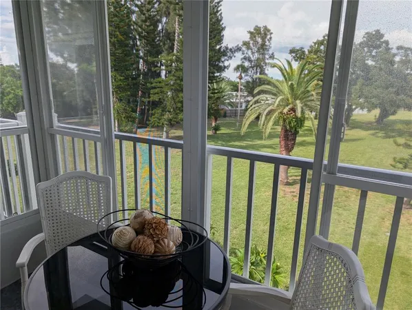 a view of a porch with furniture and wooden floor