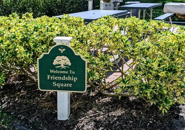 a sign that is sitting on a brick wall