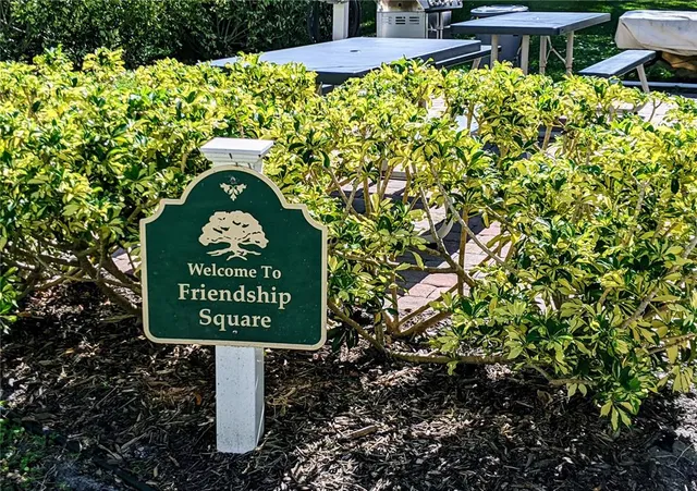 a sign that is sitting on a brick wall