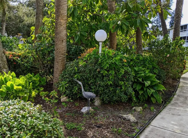 a view of a backyard of a house with a fountain