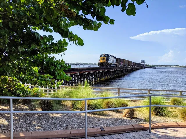 a view of a lake with boats next to a bridge