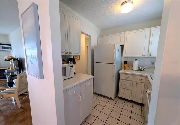 a kitchen with a refrigerator sink stove and cabinets