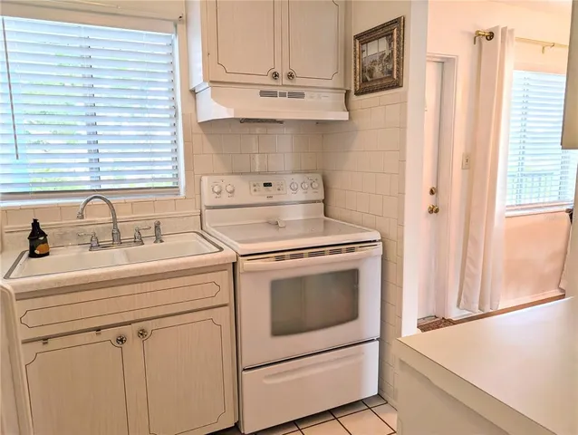 a view of a kitchen with stove and cabinets