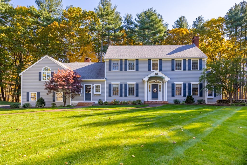136 Hartwell Road Carlisle, MA 01741 - Photo 1 of 42 a front view of a house with a big yard and large trees