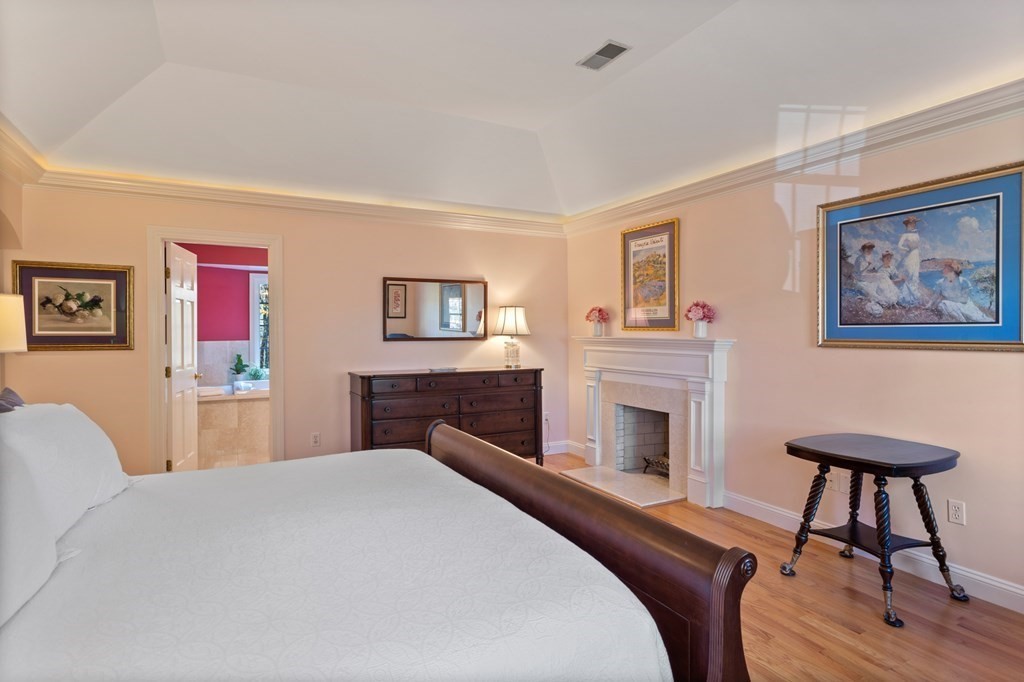 136 Hartwell Road Carlisle, MA 01741 - Photo 26 of 42 a bedroom with a bed and a fireplace