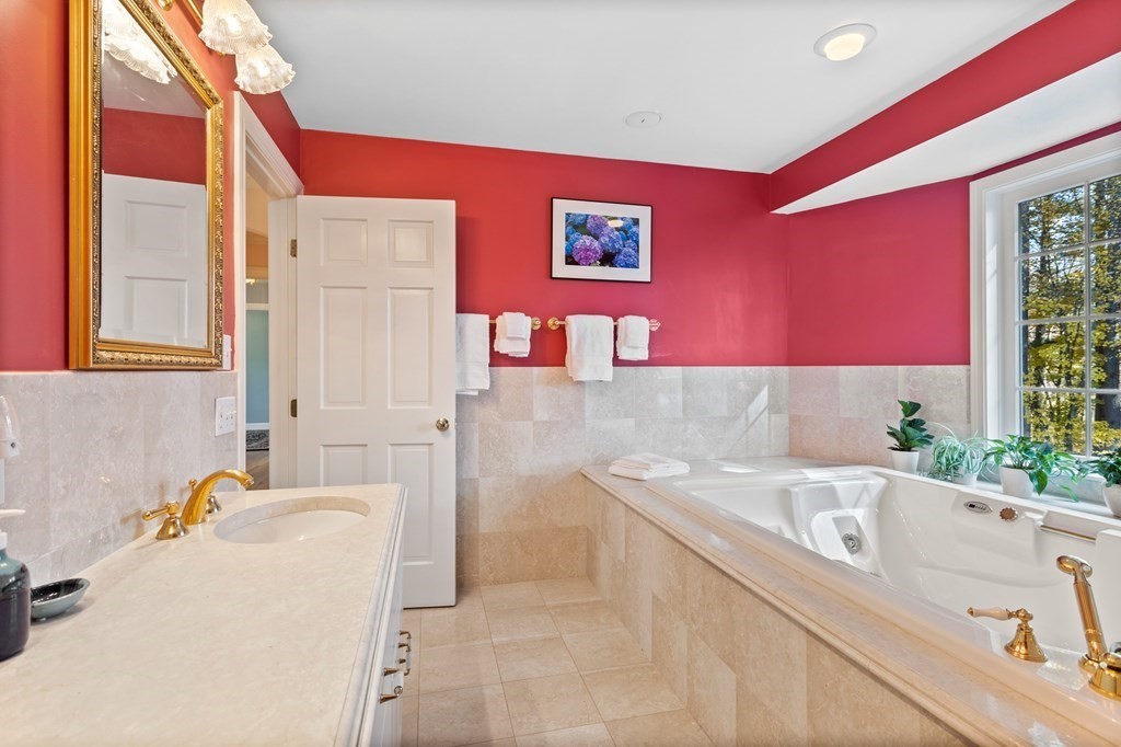 136 Hartwell Road Carlisle, MA 01741 - Photo 29 of 42 a bathroom with a granite countertop tub and a sink