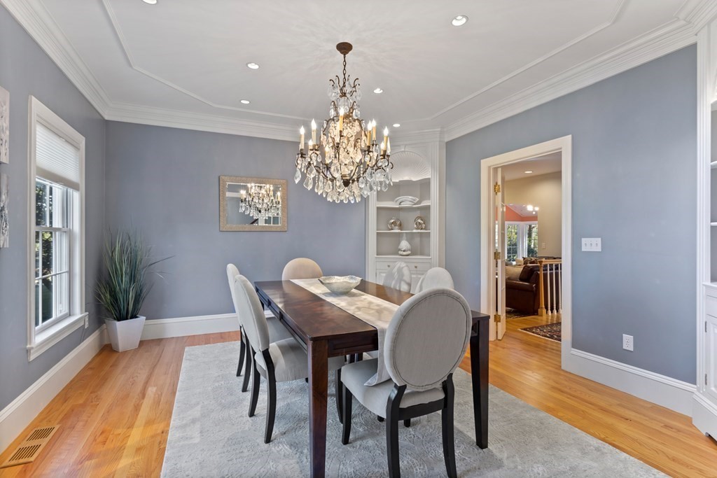 136 Hartwell Road Carlisle, MA 01741 - Photo 10 of 42 a dining room with furniture a chandelier and wooden floor