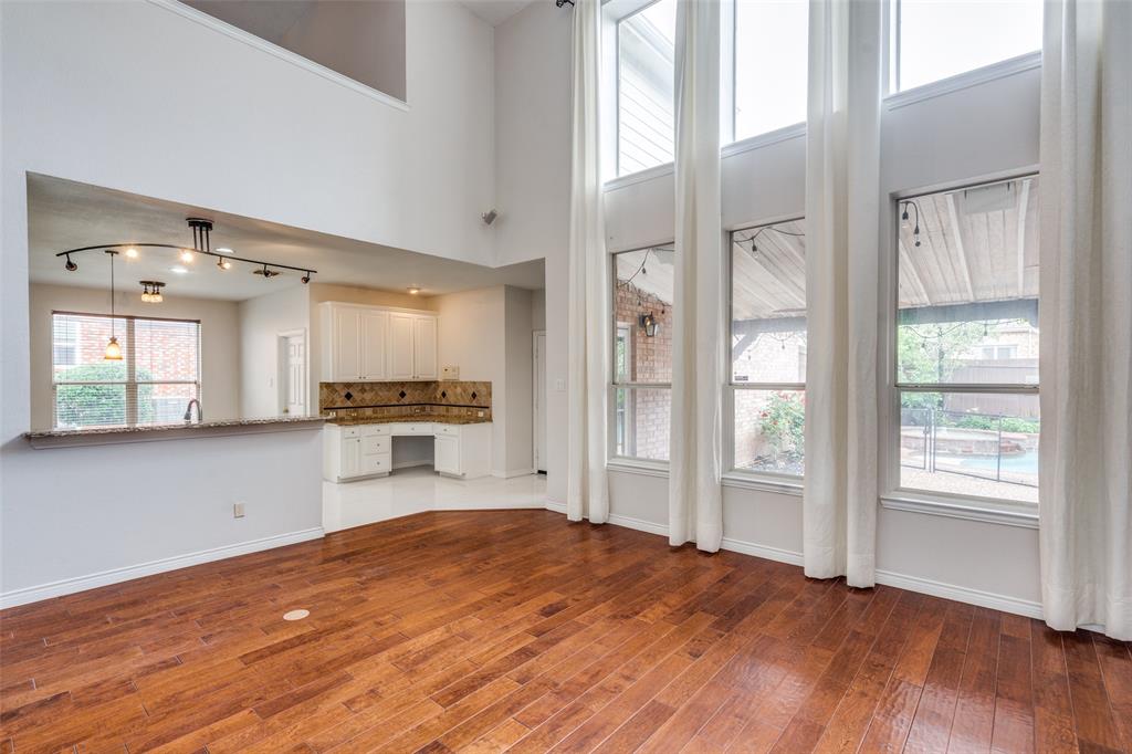 3421 Neiman Road Plano, TX 75025 - Photo 9 of 40 Unfurnished living room with wood finished floors and baseboards