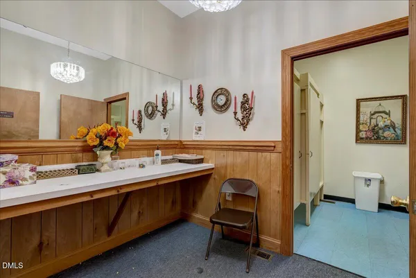 a bathroom with a sink mirror and a shower