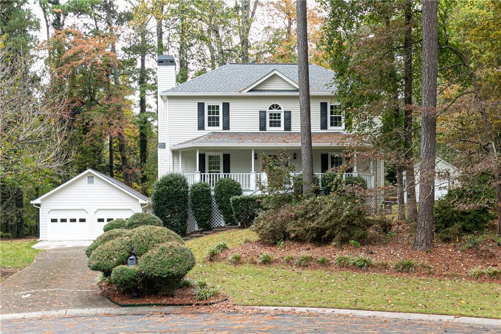 4383 Windchime Way Northwest Kennesaw, GA 30152 - Photo 1 of 1 a front view of a house with a garden