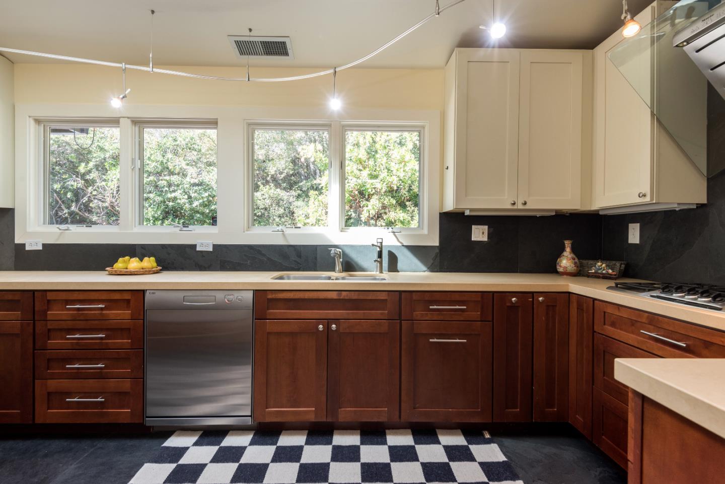 20 Ridgeway Road Hillsborough, CA 94010 - Photo 7 of 31 a kitchen with a sink window and cabinets
