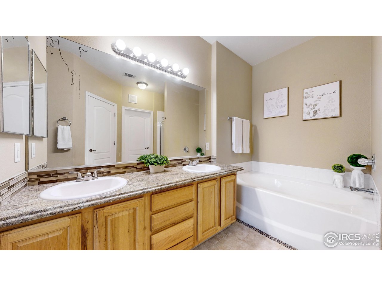 4672 West 20th Road, Unit 1823 Greeley, CO 80634 - Photo 14 of 24 Primary ensuite - double sinks, bath and shower plus toilet closet and walk-in closet