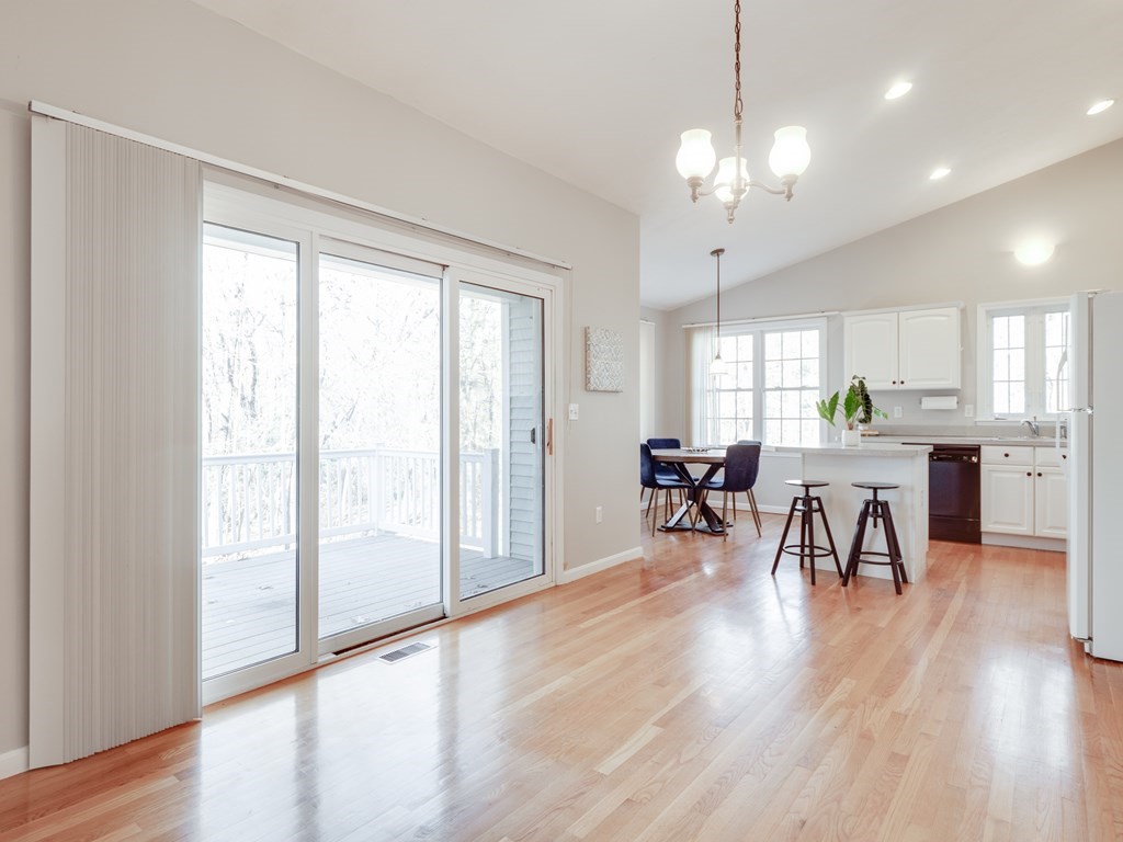 101 Stow Road, Unit 7 Boxborough, MA 01719 - Photo 12 of 32 a view of a dining room with furniture and a chandelier