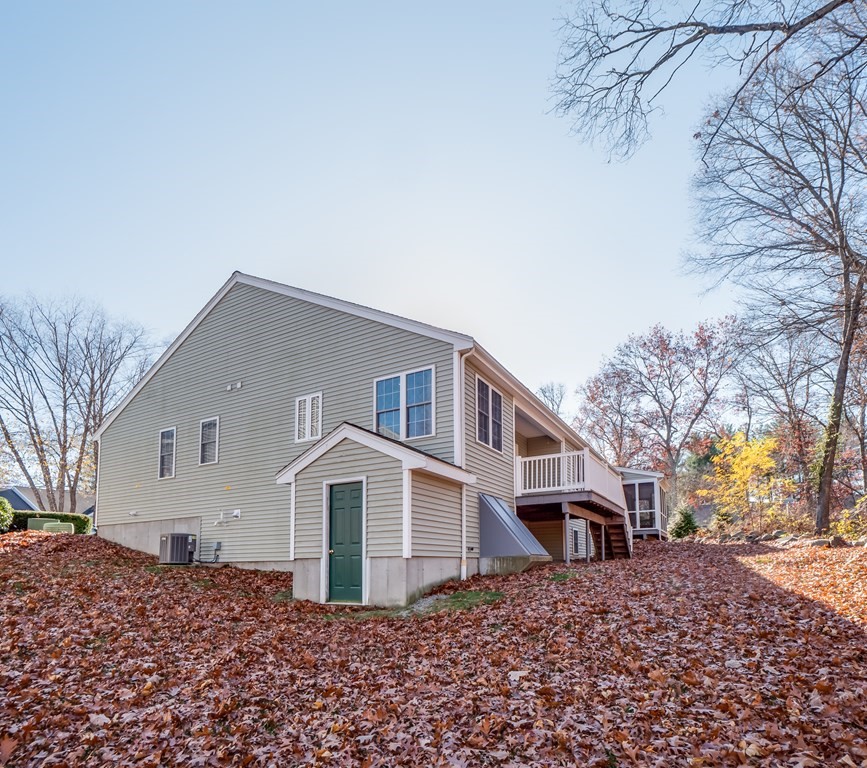 101 Stow Road, Unit 7 Boxborough, MA 01719 - Photo 3 of 32 a front view of a house with a yard
