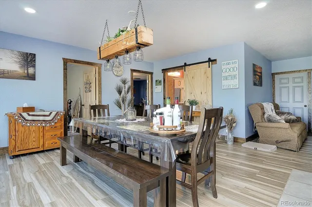 a kitchen with kitchen island granite countertop white cabinets white appliances with a sink and dishwasher