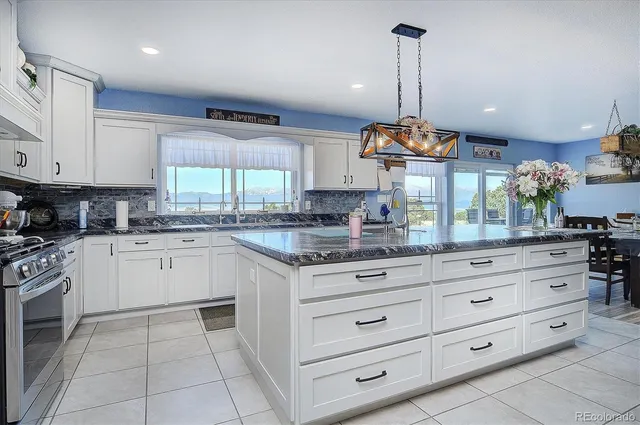 a kitchen with stainless steel appliances granite countertop a stove and a refrigerator