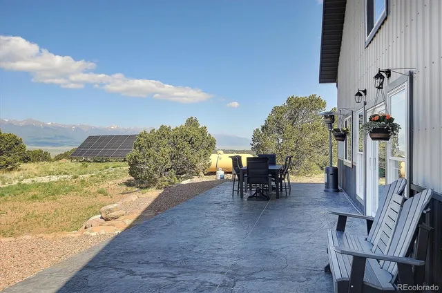 a view of a house with backyard and sitting area
