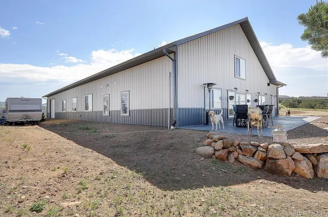 a view of a house next to a yard with road