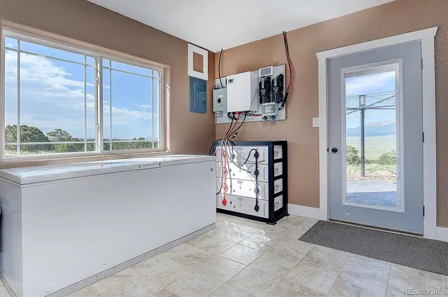 an empty room with windows cabinet and balcony