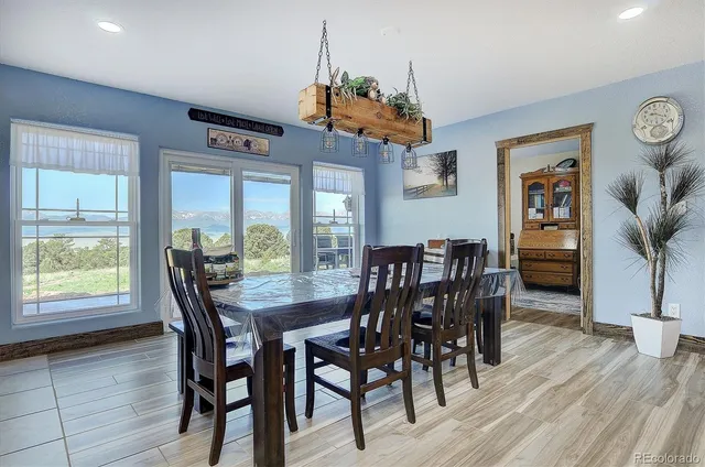 a dining table with chairs and wooden floor