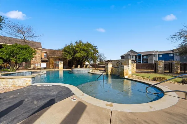 a view of a swimming pool with a patio