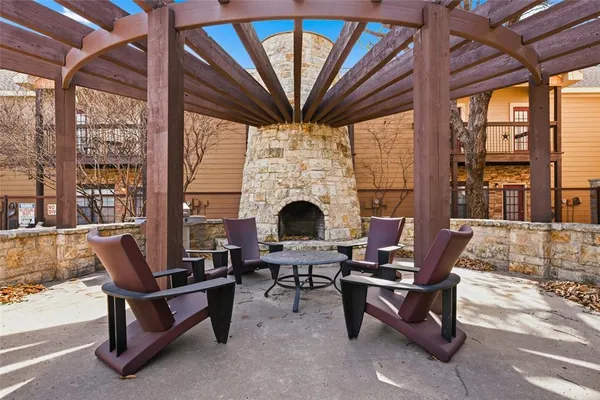 a living room with furniture a fireplace and a large window