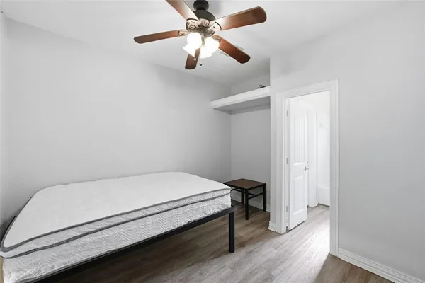 a bedroom with a bed and a ceiling fan
