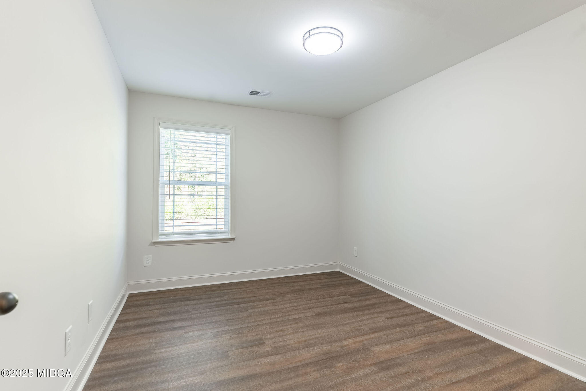 116 Fred Court Macon, GA 31216 - Photo 22 of 27 an empty room with wooden floor and window