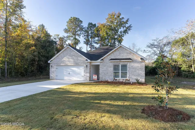 a view of a house with a swimming pool and a yard