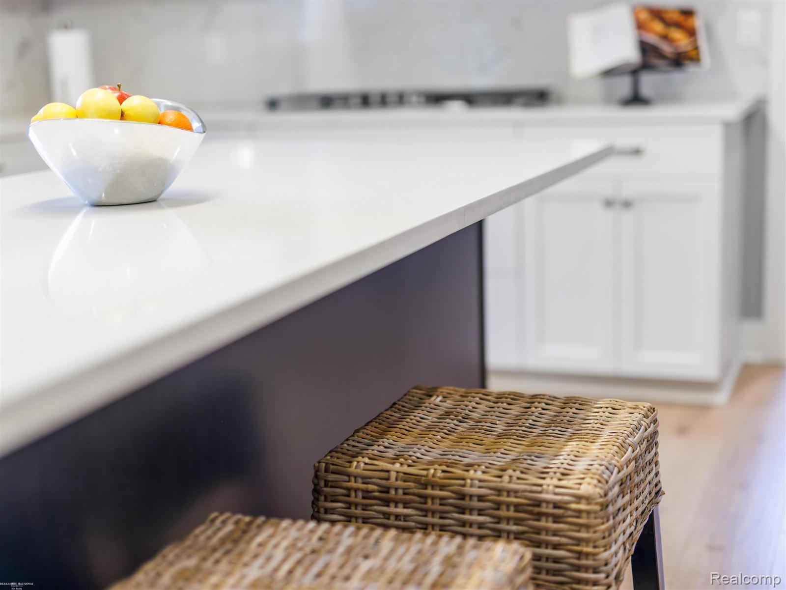 47705 Card Road Macomb, MI 48044 - Photo 13 of 53 Kitchen island featuring a white solid surface countertop and a dark base
